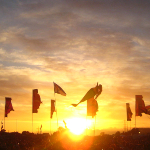 Glastonbury flags wave at sunset