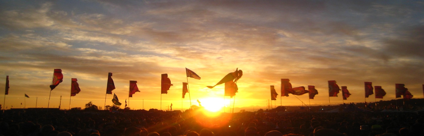 Multiple flags in a festival at sunset
