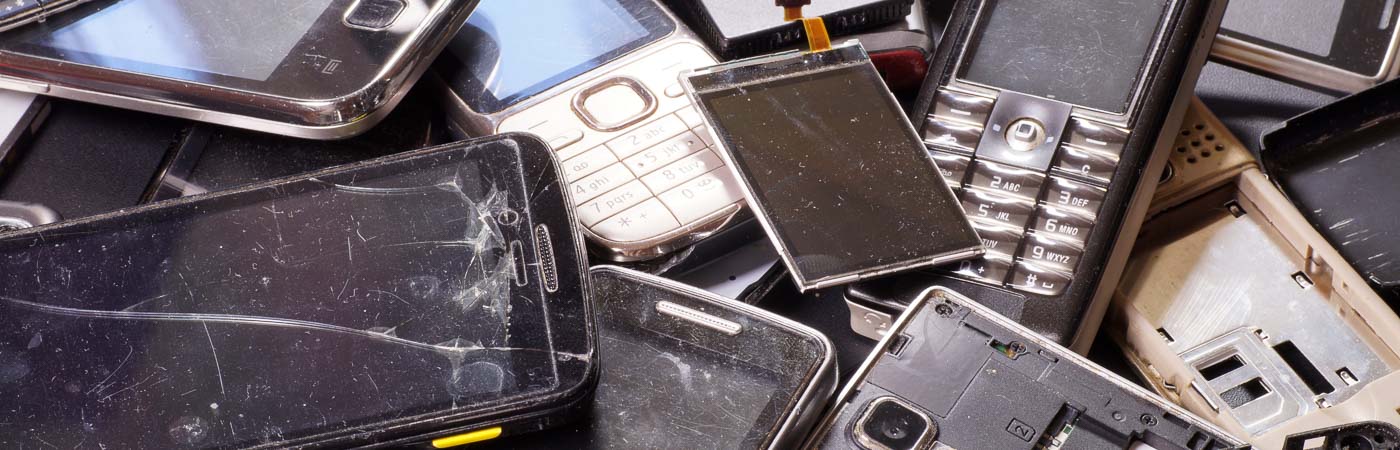 A pile of old and broken mobile phones.