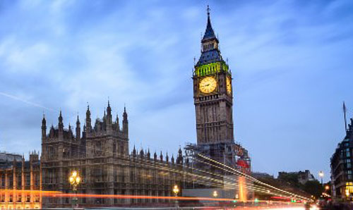 Bus light trails in front of Elizabeth Tower in London.