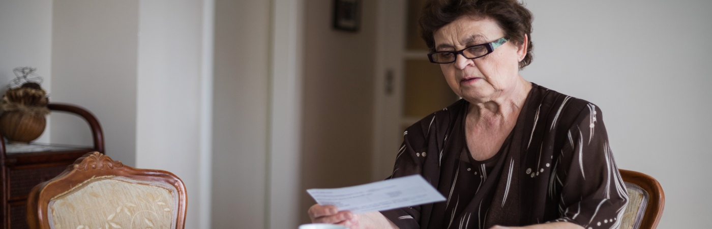 A woman looks at energy bills.