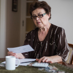 Woman looks at energy bills.