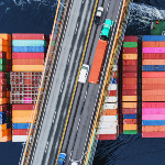 Cargo ship passes under bridge 