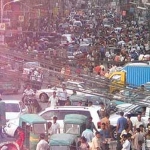 a busy road with lots of cars and people